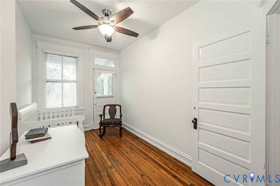 Hardwood flooring complements crisp white walls and trim