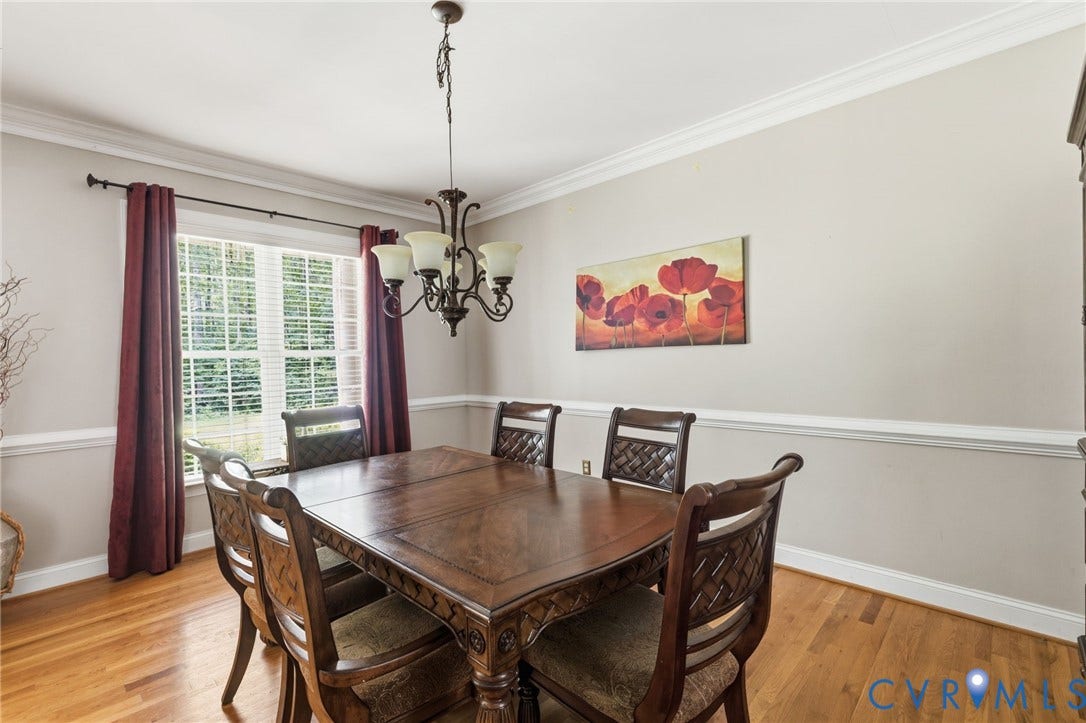3337 Scarlet Oak Drive, Powhatan, VA 23139 Formal dining space featuring crown molding, chair rail detailing, wood-finish flooring, and a chandelier