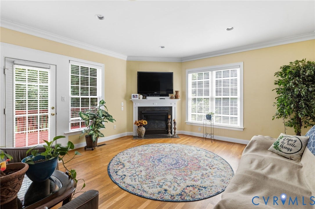 3337 Scarlet Oak Drive, Powhatan, VA 23139 Hardwood flooring throughout featuring a corner fireplace with a white mantel, recessed lighting