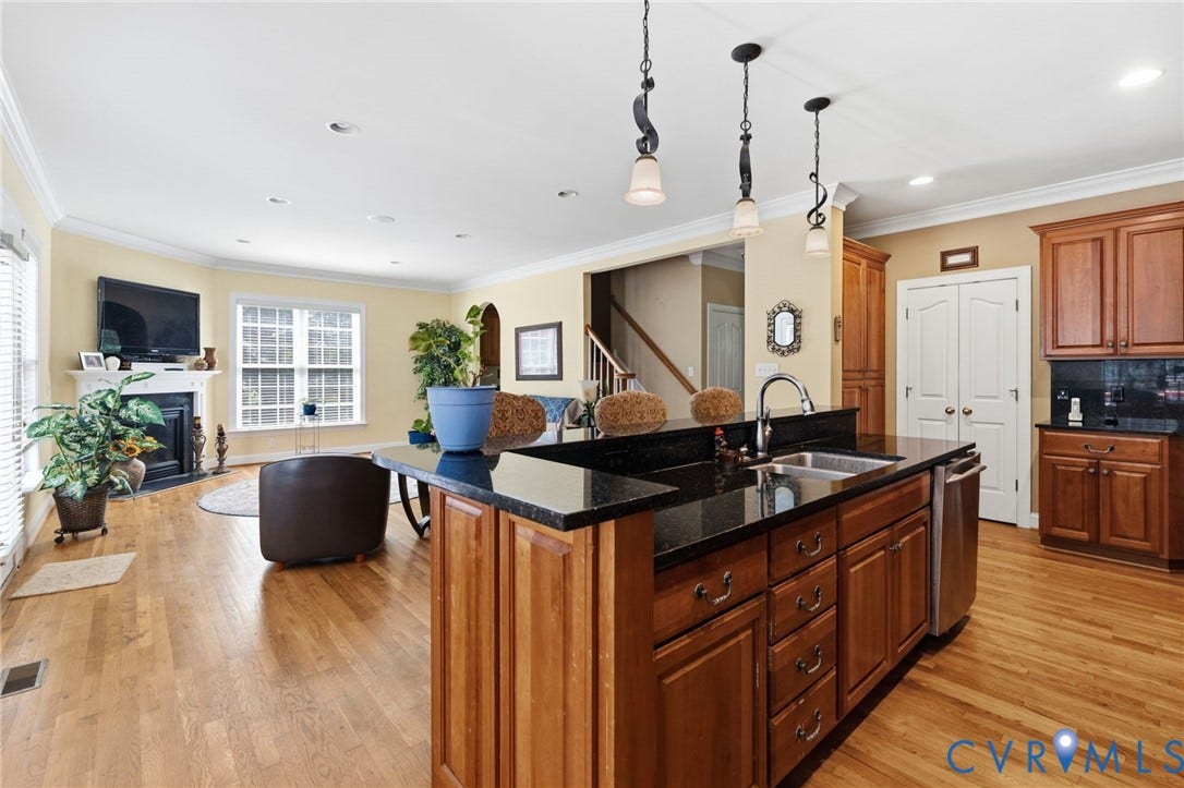 3337 Scarlet Oak Drive, Powhatan, VA 23139 Kitchen island featuring a stainless steel sink, dark countertop, and pendant lighting