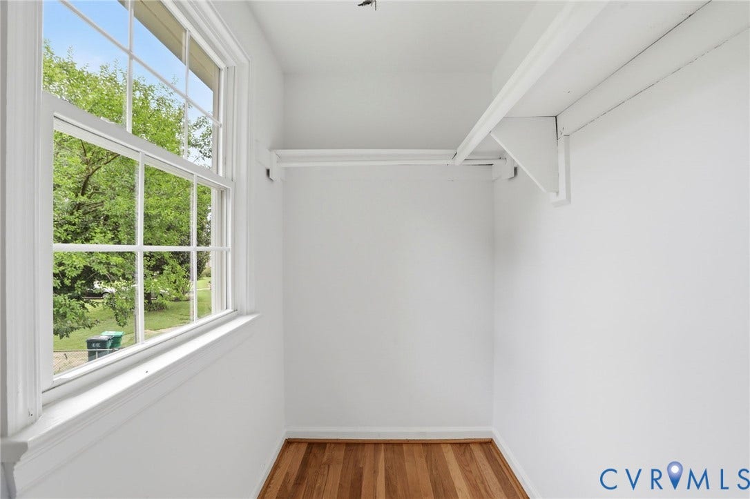 5301 Dalglish Road, Henrico, VA 23223 Bright space featuring a multi-pane window, wood-finish flooring, and a built-in shelf and hanging rod
