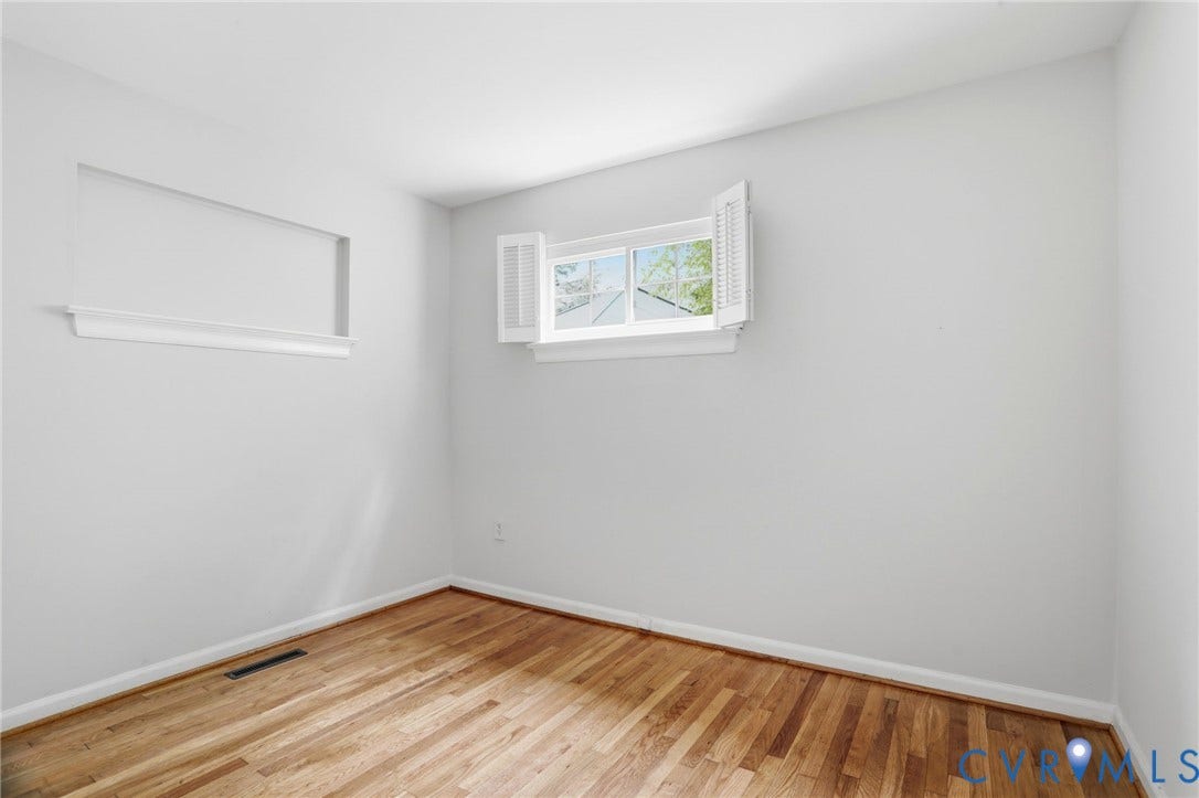 5301 Dalglish Road, Henrico, VA 23223 Hardwood flooring throughout this room featuring white walls, white baseboards, and a window with white shutters