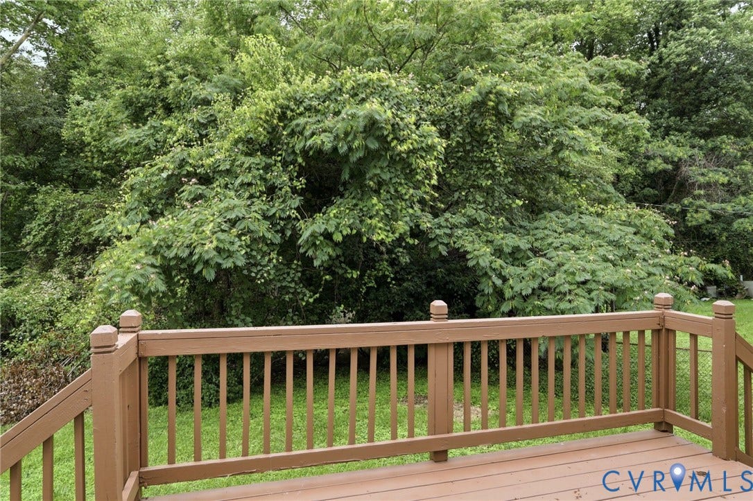 5301 Dalglish Road, Henrico, VA 23223 Expansive outdoor deck with brown-stained wood surfaces and a surrounding natural green landscape