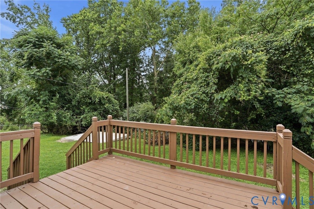5301 Dalglish Road, Henrico, VA 23223 Wood-finish deck with full railings and steps, overlooking a level lawn and mature trees