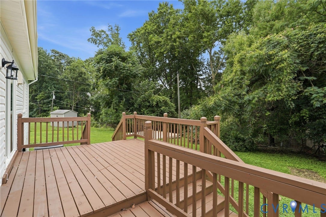 5301 Dalglish Road, Henrico, VA 23223 Expansive exterior deck featuring a rich brown finish, full balustrade railing, and integrated steps