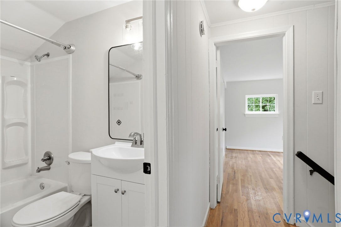 5301 Dalglish Road, Henrico, VA 23223 Full bathroom featuring a white tub/shower combination, white vanity with integrated sink, and an illuminated mirror