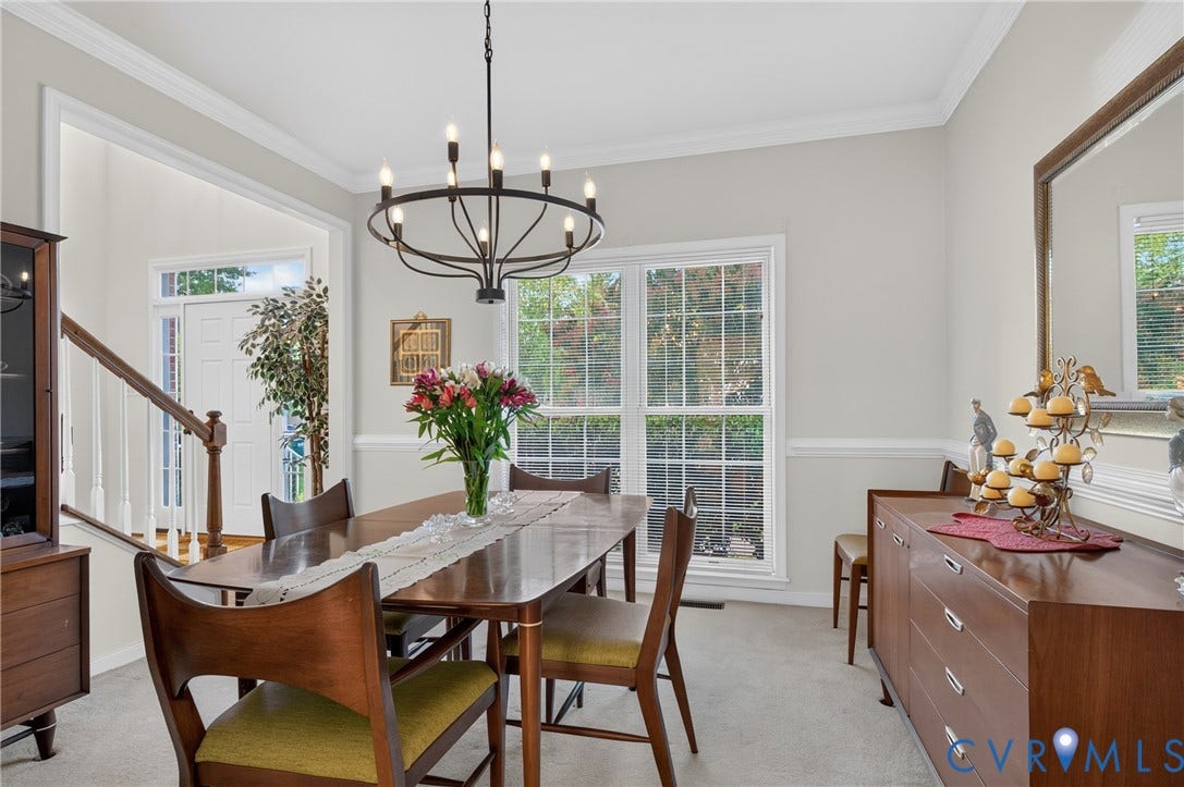 10817 Correnty Drive, Glen Allen, VA 23059 Dining area featuring a contemporary chandelier, two-tone wall paint, crown molding, and large window
