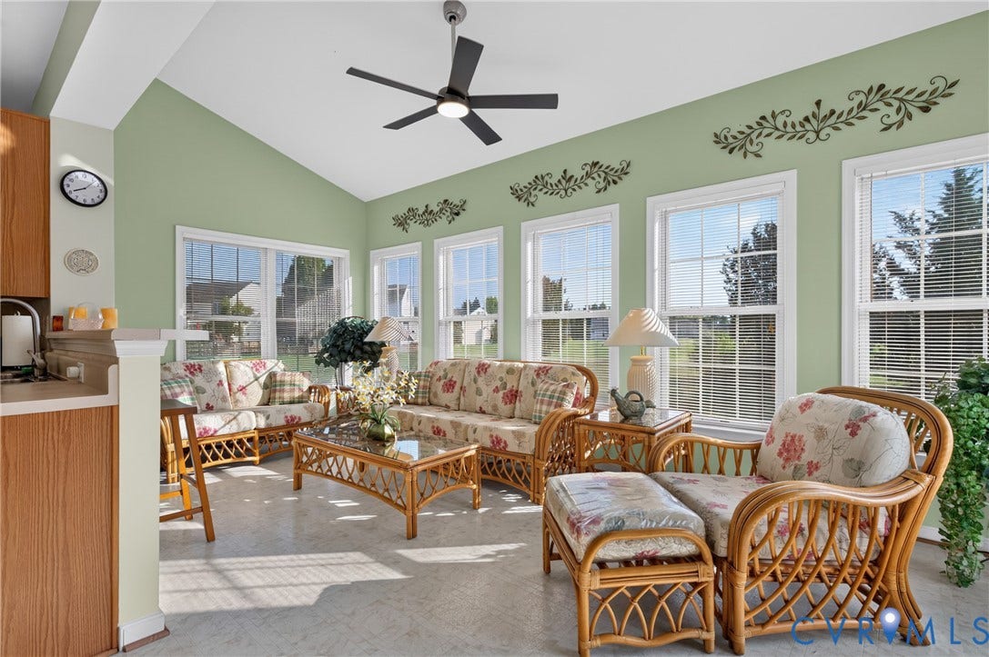 10817 Correnty Drive, Glen Allen, VA 23059 Sunroom featuring a vaulted ceiling with a ceiling fan, multiple windows with white blinds, light green walls with decorative stenciling, and light-colored flooring