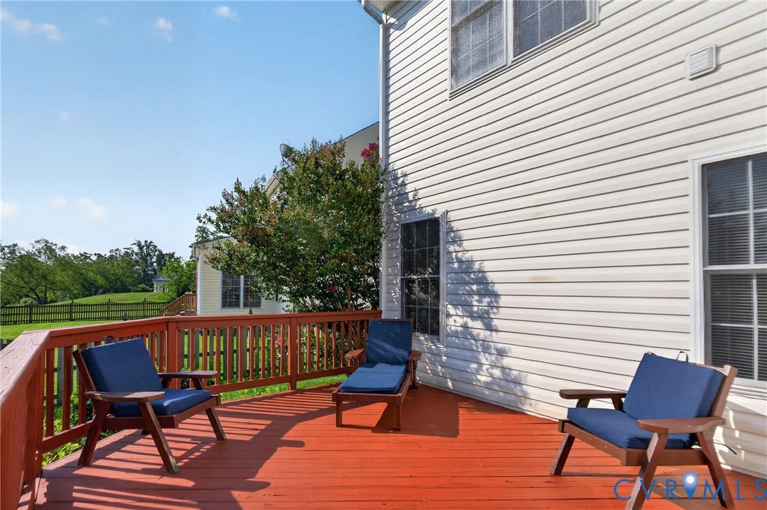 10817 Correnty Drive, Glen Allen, VA 23059 Expansive outdoor wood deck with a stained finish and wooden railings, presenting a broad open-air space