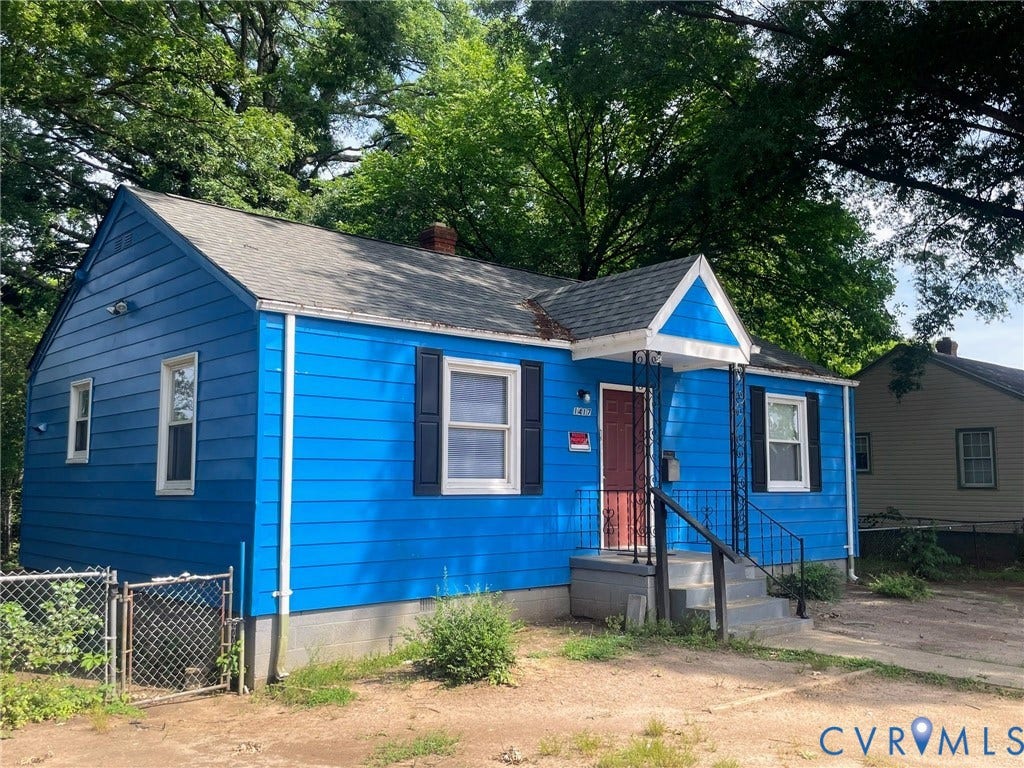 1417 Bowen Street, Oak Grove, Richmond, VA 23224 Vibrant blue siding, ample parking in driveway, mature trees surround home for privacy and shade