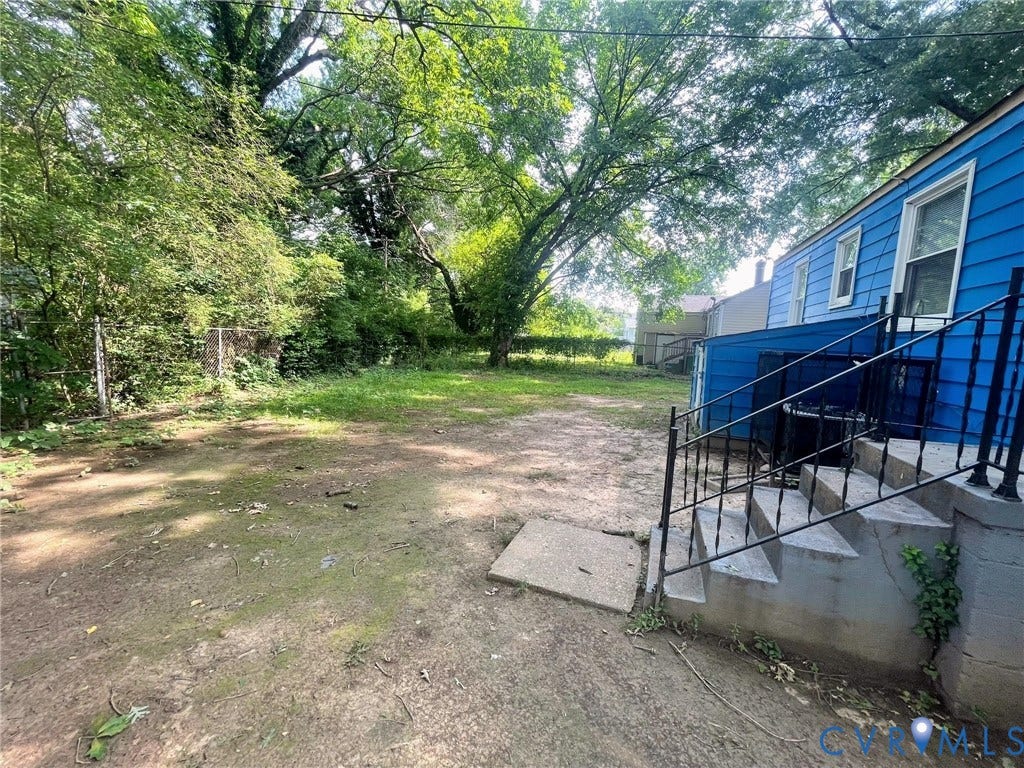 1417 Bowen Street, Oak Grove, Richmond, VA 23224 Spacious rear yard with mature trees and a chain-link fence