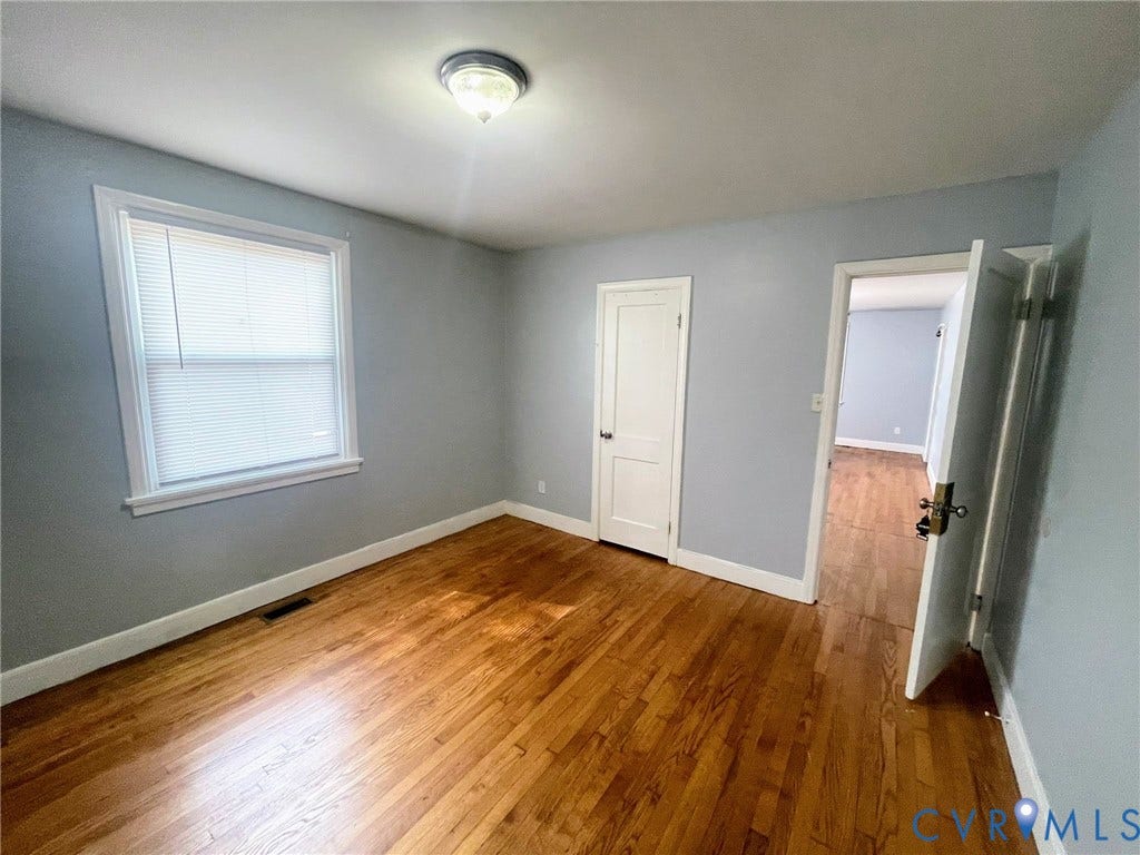 1417 Bowen Street, Oak Grove, Richmond, VA 23224 Room featuring wood flooring, window with blinds, and neutral wall paint