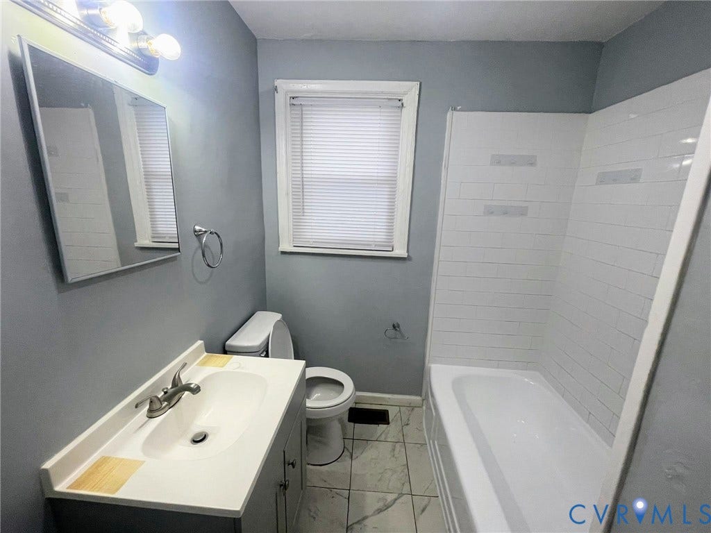 1417 Bowen Street, Oak Grove, Richmond, VA 23224 Bathroom featuring a bathtub with subway tile surround, gray vanity with integrated sink, chrome colored faucet, and tiled flooring