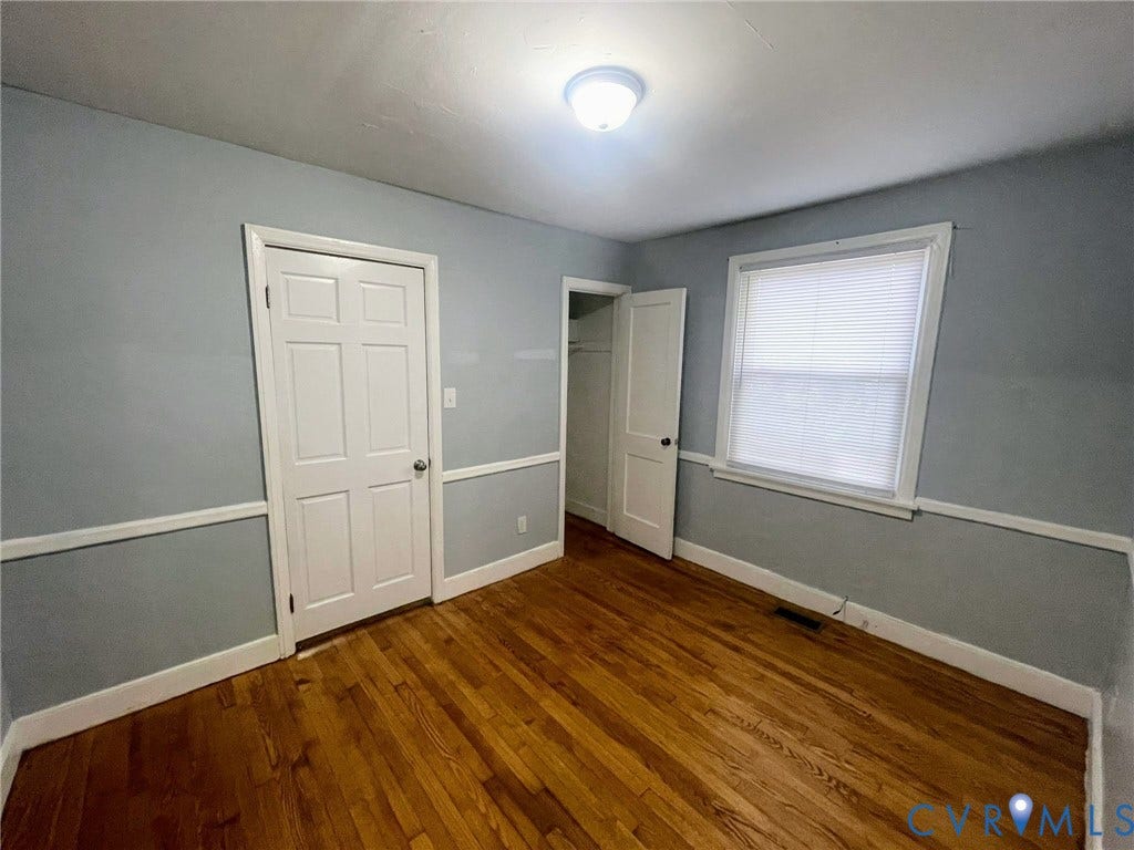 1417 Bowen Street, Oak Grove, Richmond, VA 23224 Bedroom featuring wood flooring and neutrally painted walls with white trim. This room also has elegant chair rail molding