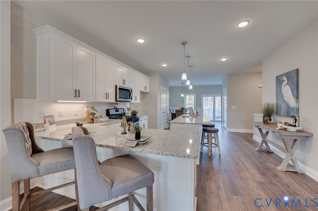 6408 Sanford Springs Cove, Midlothian, VA 23112 Spacious kitchen featuring white shaker cabinetry, speckled countertops, and a subway tile backsplash