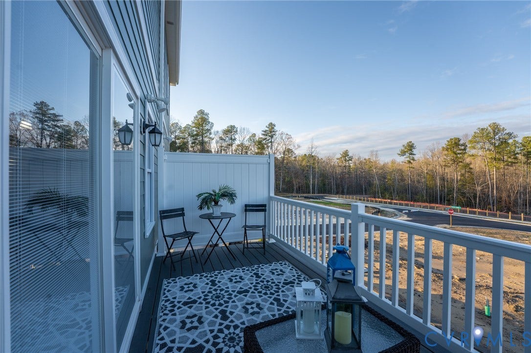 6408 Sanford Springs Cove, Midlothian, VA 23112 Private balcony featuring composite decking, white railing, and exterior wall lighting