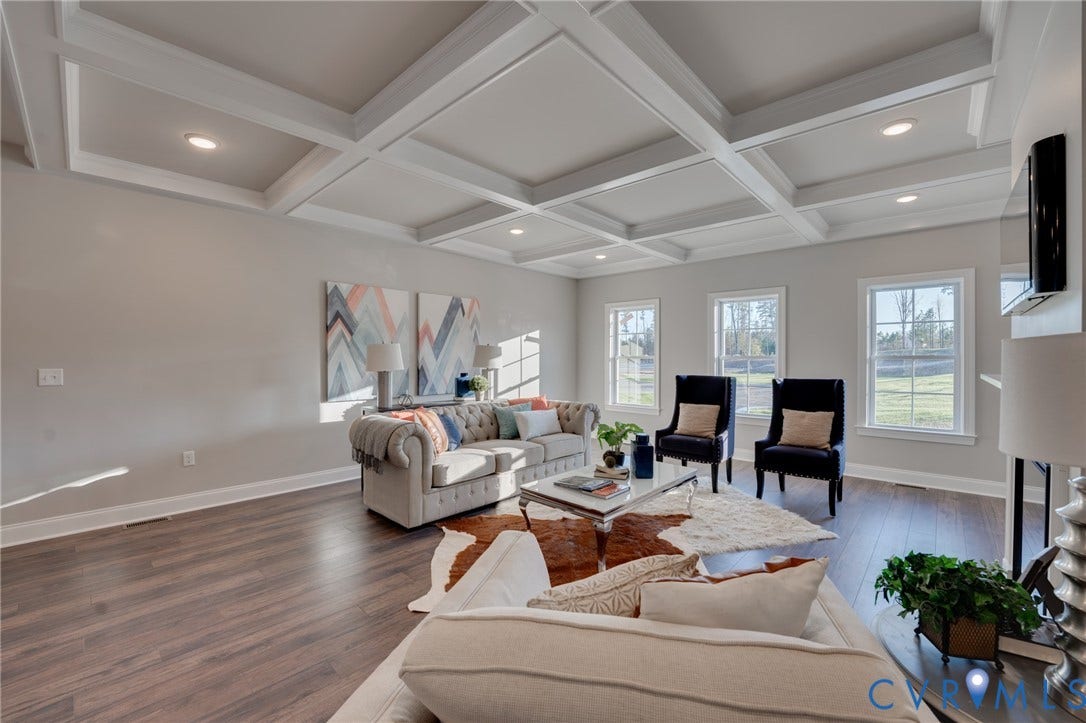 6408 Sanford Springs Cove, Midlothian, VA 23112 Spacious living area featuring a coffered ceiling, recessed lighting, wood-finish flooring, and multiple windows with white trim