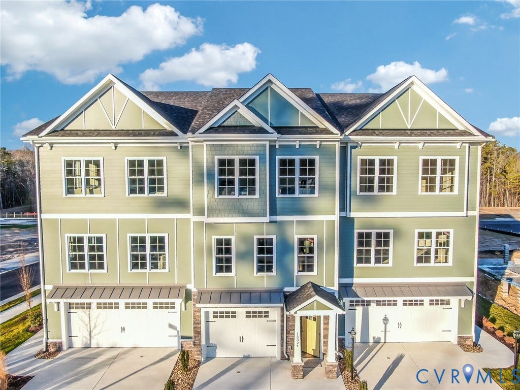6408 Sanford Springs Cove, Midlothian, VA 23112 Contemporary townhome exterior featuring multi-toned siding, white trim, multiple gables, a shingled roof, and individual garage doors
