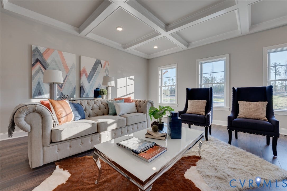 6408 Sanford Springs Cove, Midlothian, VA 23112 Spacious living area featuring a coffered ceiling, recessed lighting, wood-finish flooring, multiple windows, and light gray wall tones