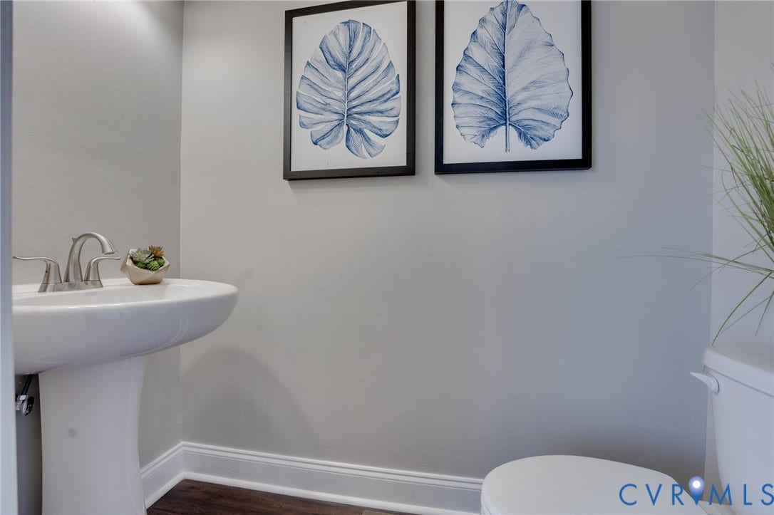 6408 Sanford Springs Cove, Midlothian, VA 23112 Pedestal sink with brushed nickel faucet, wood-finish flooring, and light gray wall paint