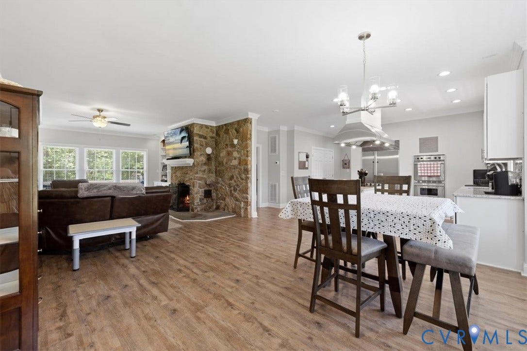 Open-concept living space featuring wood-finish flooring throughout