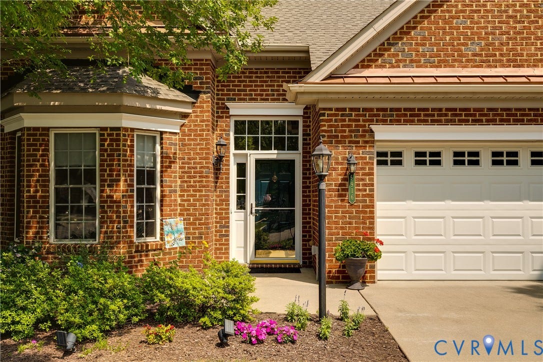 Welcoming Front Entry Featuring Professionally Manicured Landscaping.