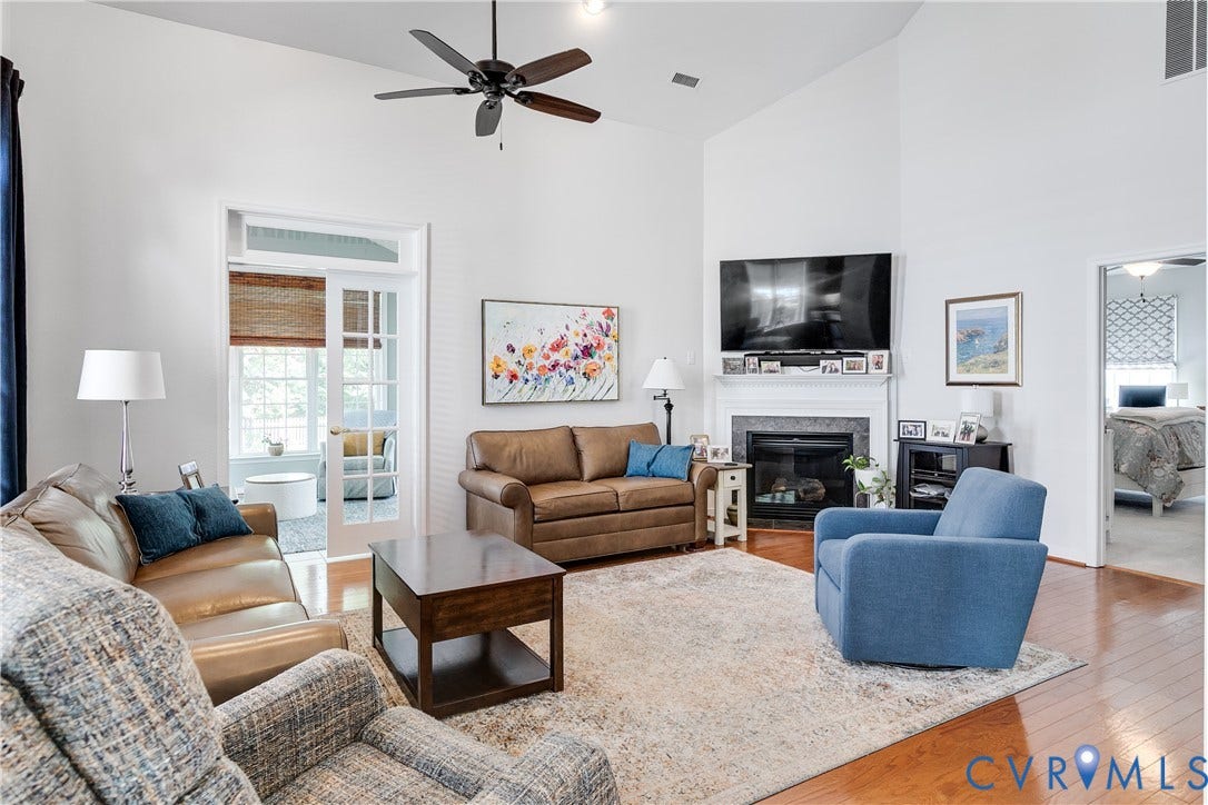 Family Room Featuring Hardwood Flooring, Ceiling Fan, and Cathedral Ceiling.