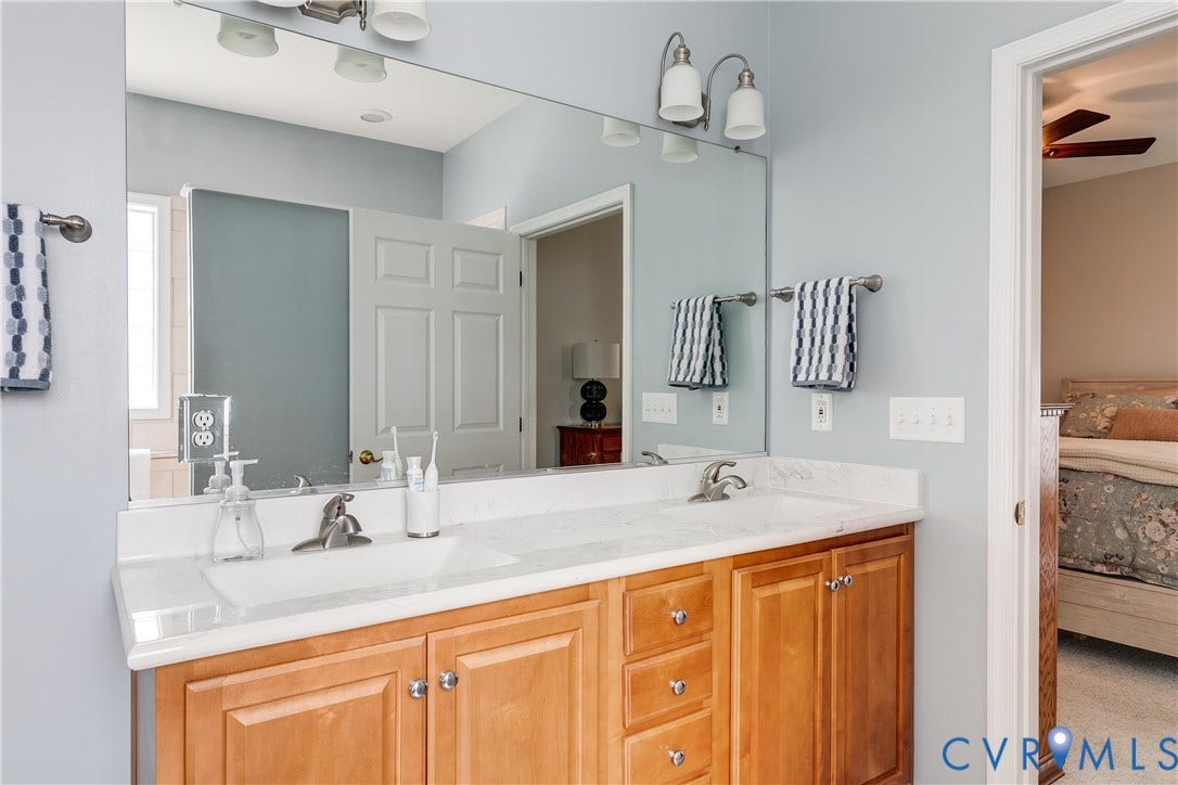 Primary En-Suite Bath Featuring Double Vanity.
