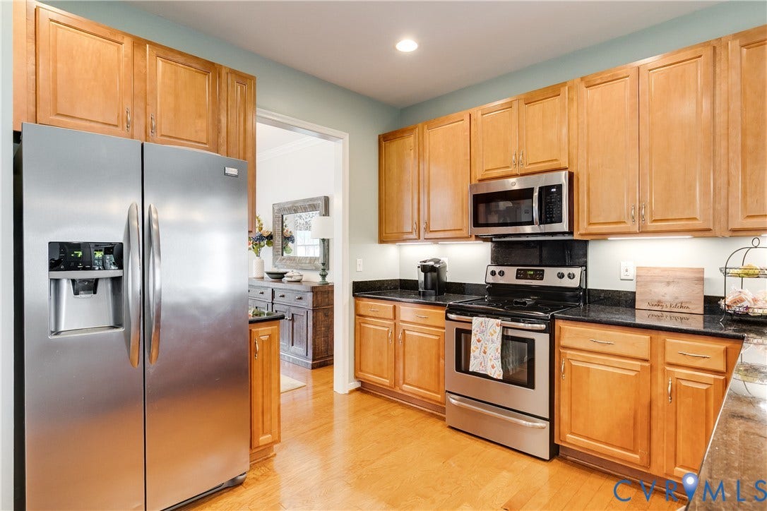 Kitchen Featuring Stainless-Steel Appliances and Granite Countertops.