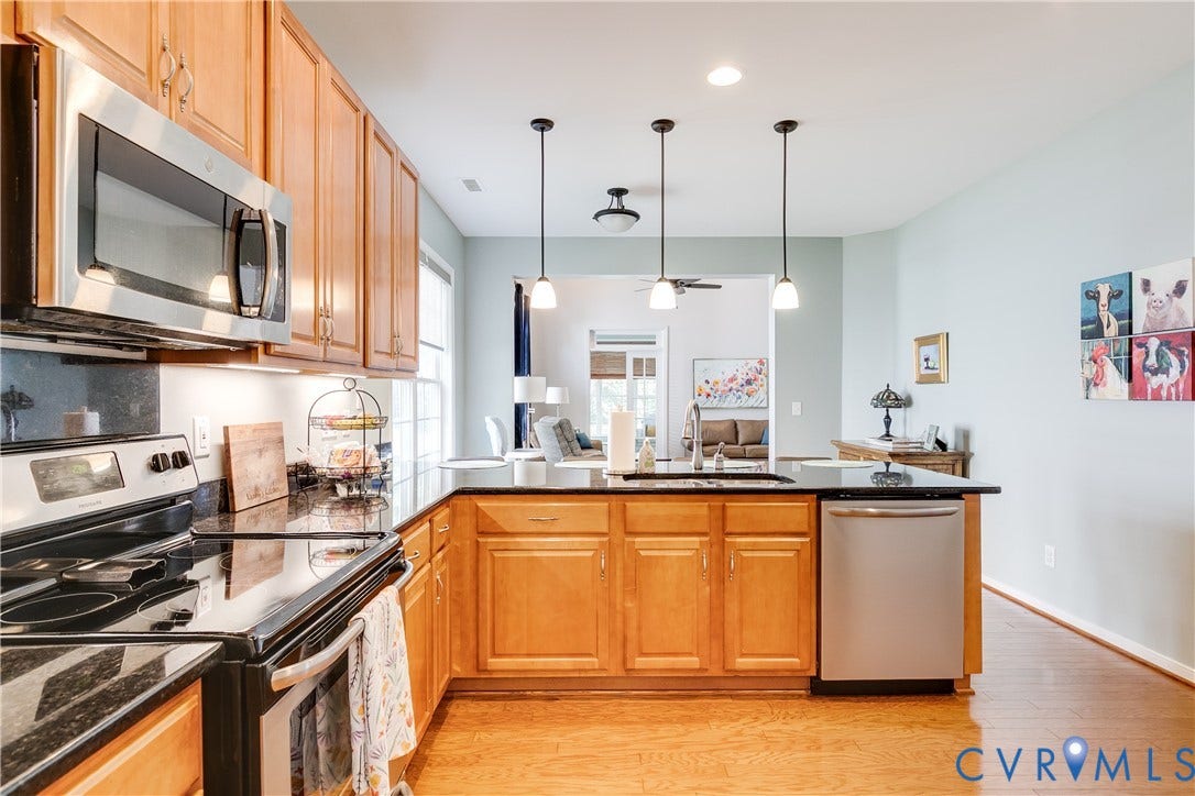 Kitchen Featuring Stainless-Steel Electric Cooktop, Microwave, and Dishwasher.