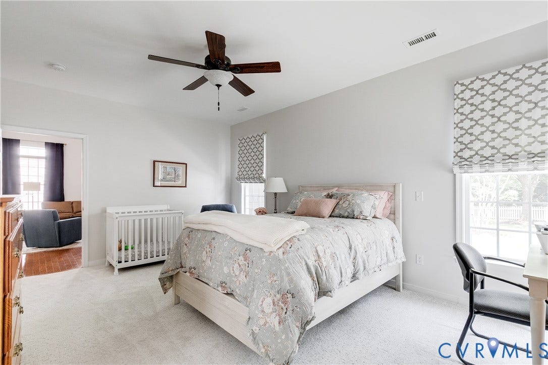 Primary Bedroom Featuring Carpet and Ceiling Fan.