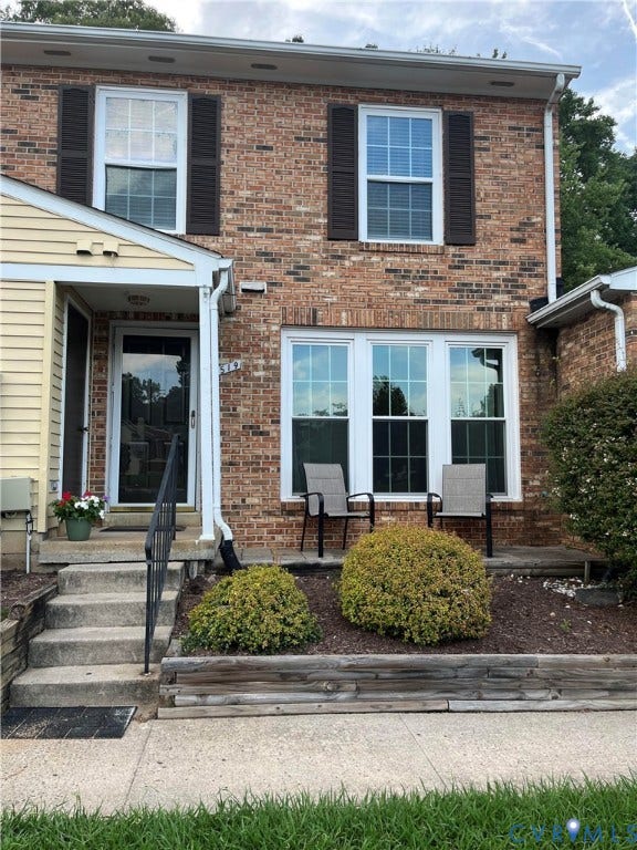 1519 Harpers Ferry Court, Henrico, VA 23228 Brick and siding exterior featuring white-framed windows with dark shutters