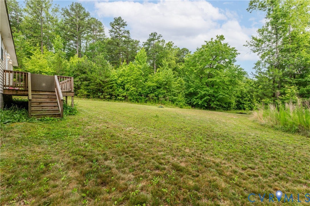 24580 St James Road, Amelia, VA 23083 Expansive green lawn with a natural tree line backdrop