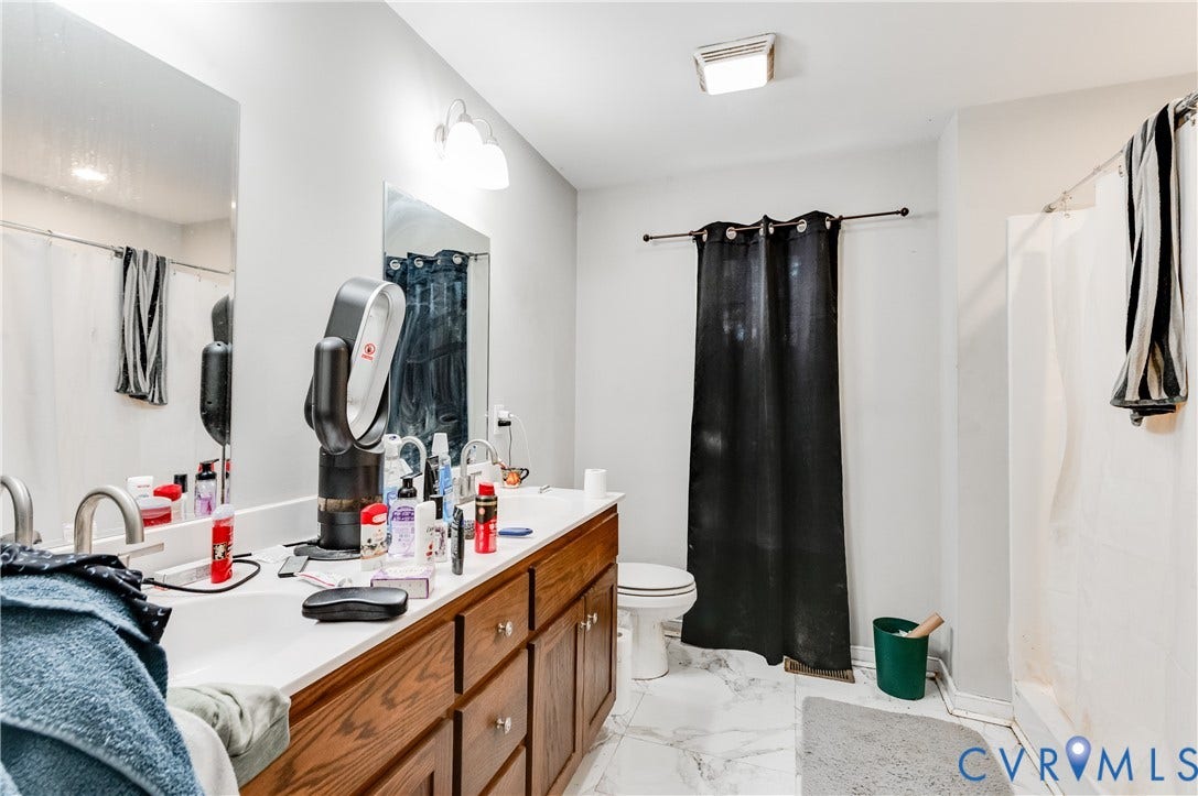 24580 St James Road, Amelia, VA 23083 Bathroom featuring a dual vanity with a white countertop and wood cabinetry