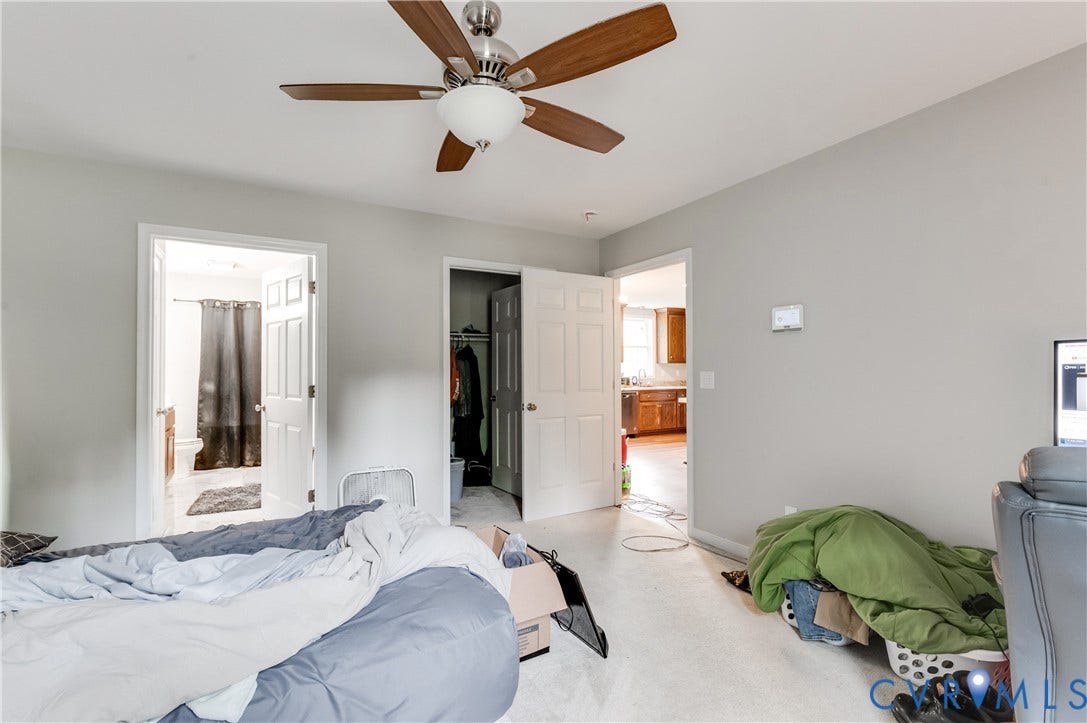 24580 St James Road, Amelia, VA 23083 Carpeted room with a ceiling fan featuring wood-finish blades, light gray walls, and white trim