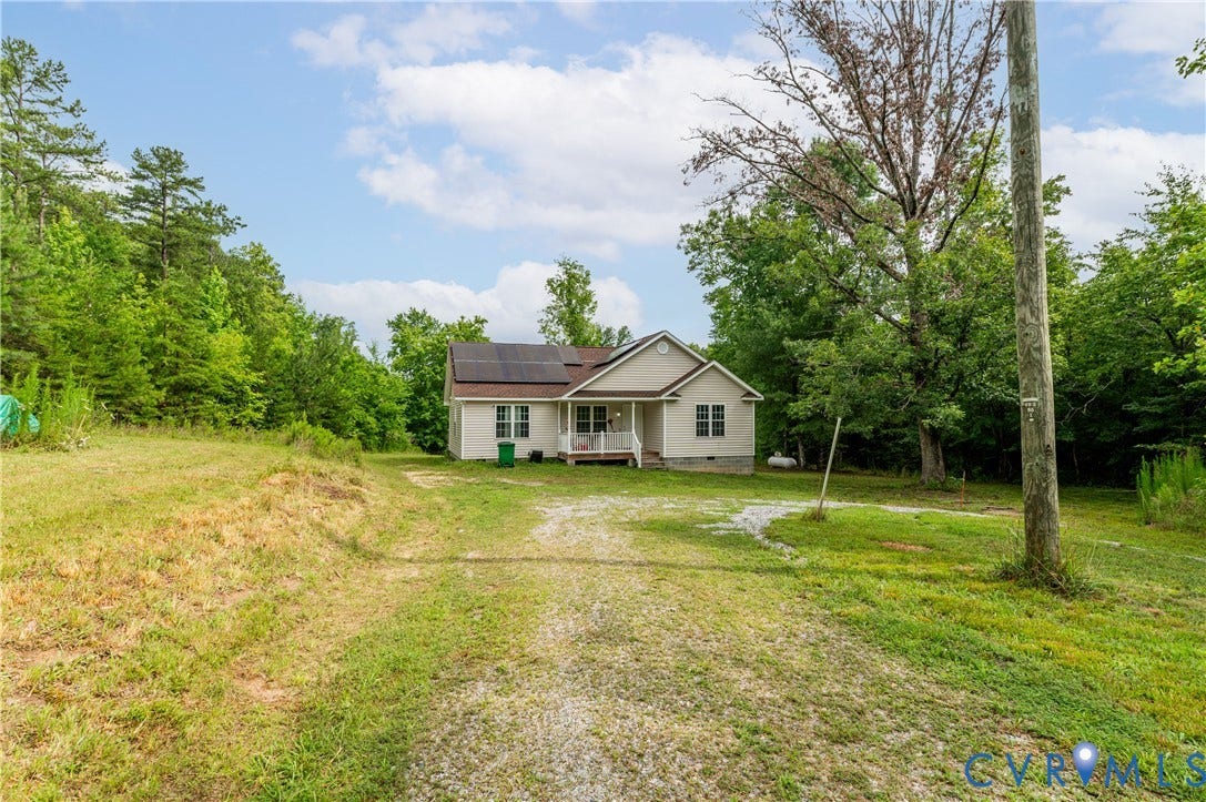 24580 St James Road, Amelia, VA 23083 Single-story residence featuring a covered front porch and a gravel driveway