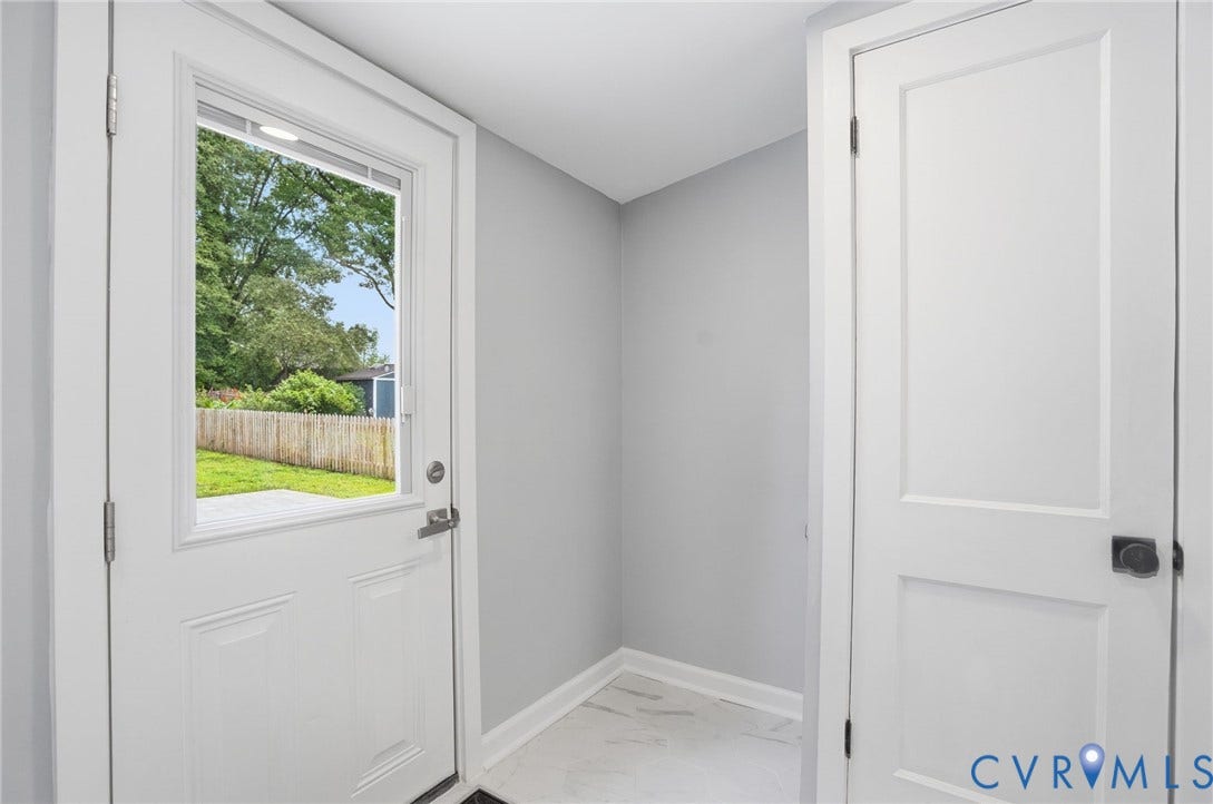 6929 Woodrow Terrace, Richmond, VA 23228 Rear entry door with integrated window, durable tile flooring, crisp white trim, and light gray wall tones