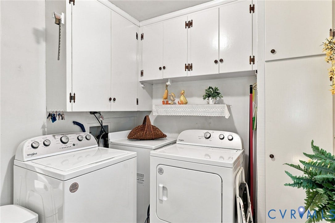 4001 Saldale Drive, North Chesterfield, VA 23237 Built-in cabinetry with decorative hardware, white subway tile wainscoting, white vanity with integrated sink, tiled flooring, and a window with white shutters