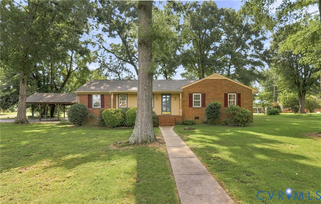 4001 Saldale Drive, North Chesterfield, VA 23237 Hardwood-style flooring, brick fireplace with metal insert, two built-in shelving units, ceiling fan, and white paneling