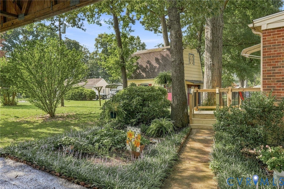 4001 Saldale Drive, North Chesterfield, VA 23237 Brick and siding exterior with a covered porch, mature landscaping, and a concrete walkway