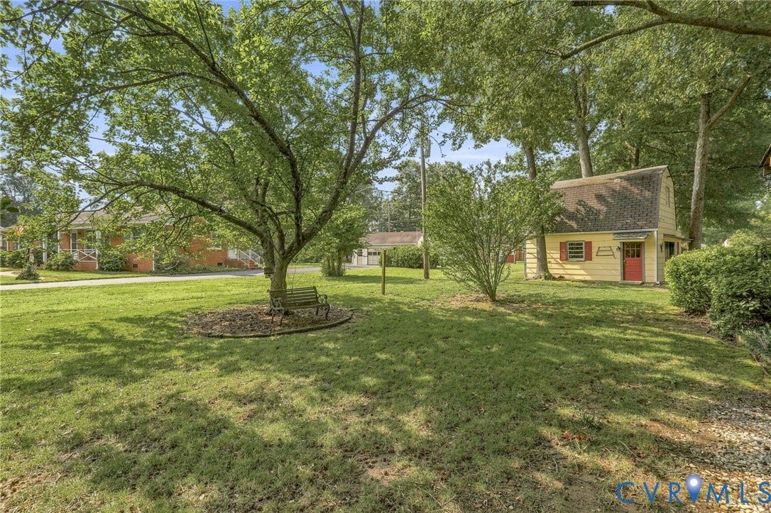 4001 Saldale Drive, North Chesterfield, VA 23237 Brick and siding exterior with red shutters, a covered carport, and mature trees