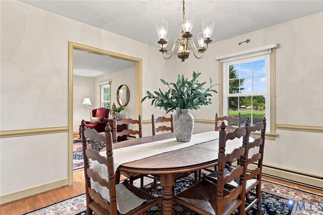 4001 Saldale Drive, North Chesterfield, VA 23237 Hardwood flooring, two windows with white trim, a ceiling fan with integrated lighting, and light-colored wall paint