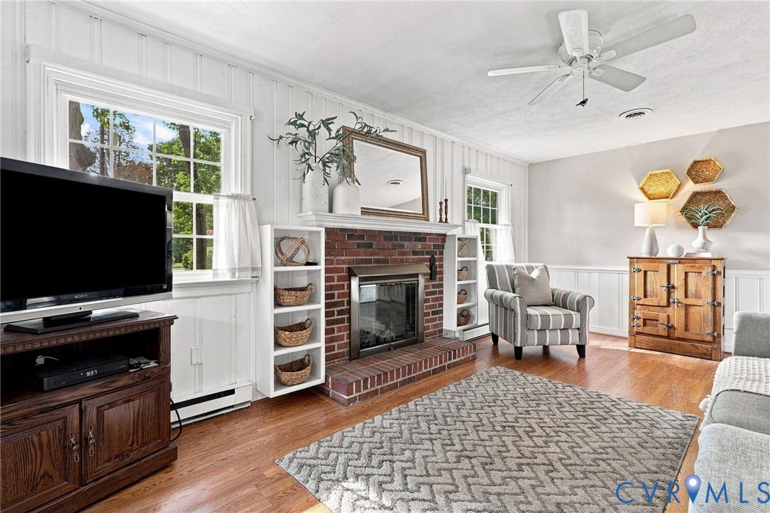 4001 Saldale Drive, North Chesterfield, VA 23237 Overhead chandelier, window with exterior landscaping, wall-mounted decorative panels, and crown molding