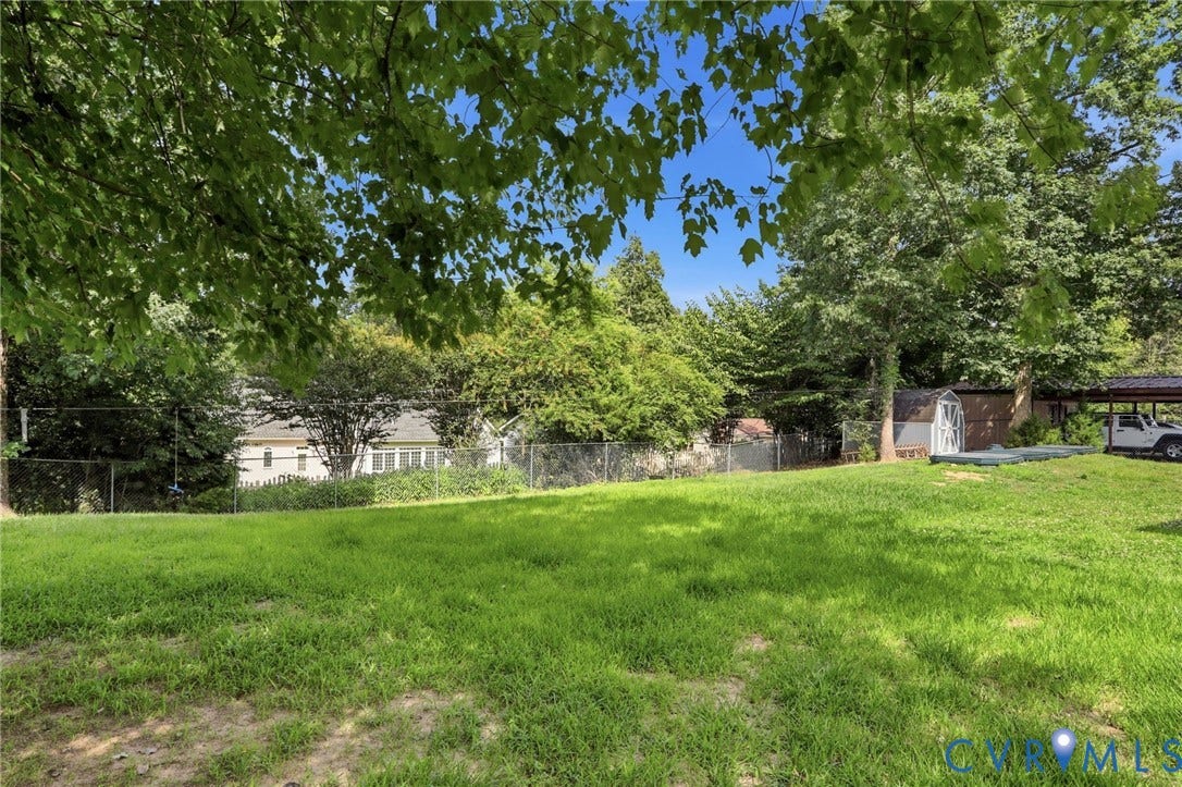 Expansive grassy yard with mature trees