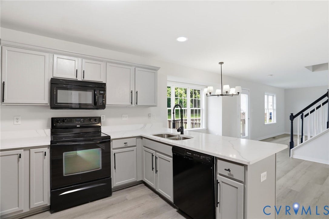 6412 Autumn Mist Way, Chesterfield, VA 23832 Bright kitchen featuring light-toned cabinetry, white countertops, and black appliances
