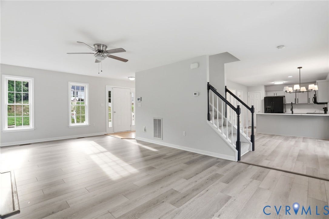 6412 Autumn Mist Way, Chesterfield, VA 23832 Spacious living area featuring light wood-finish flooring, a ceiling fan, and multiple windows