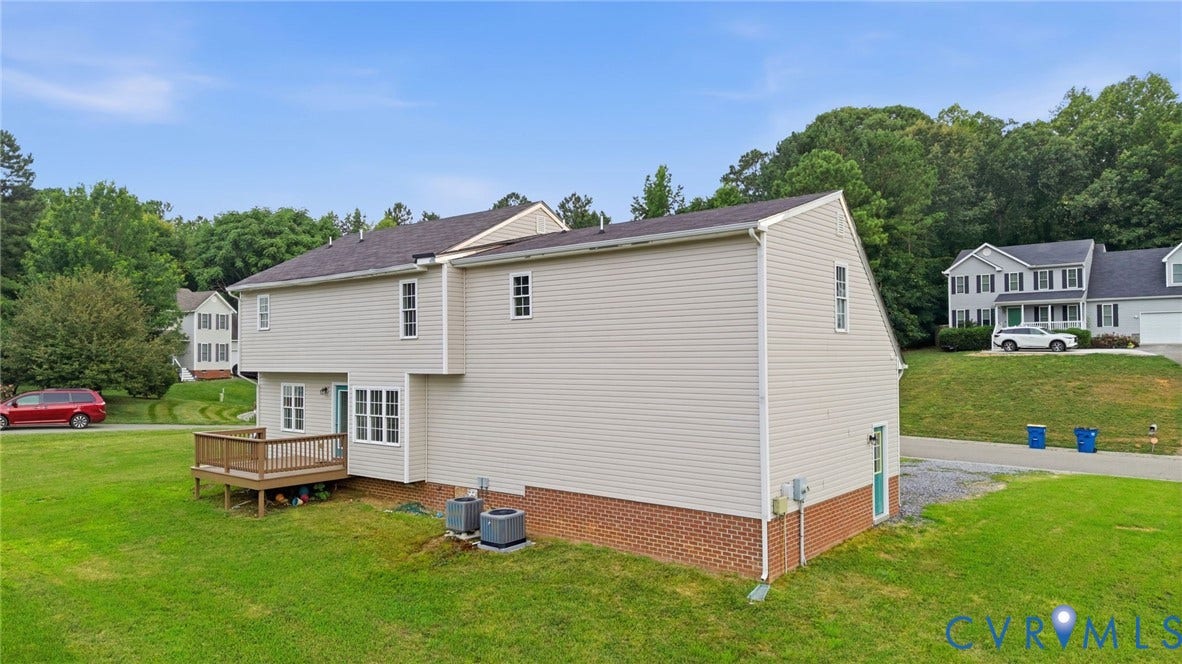 6412 Autumn Mist Way, Chesterfield, VA 23832 Rear exterior with light-toned siding and a brown brick foundation