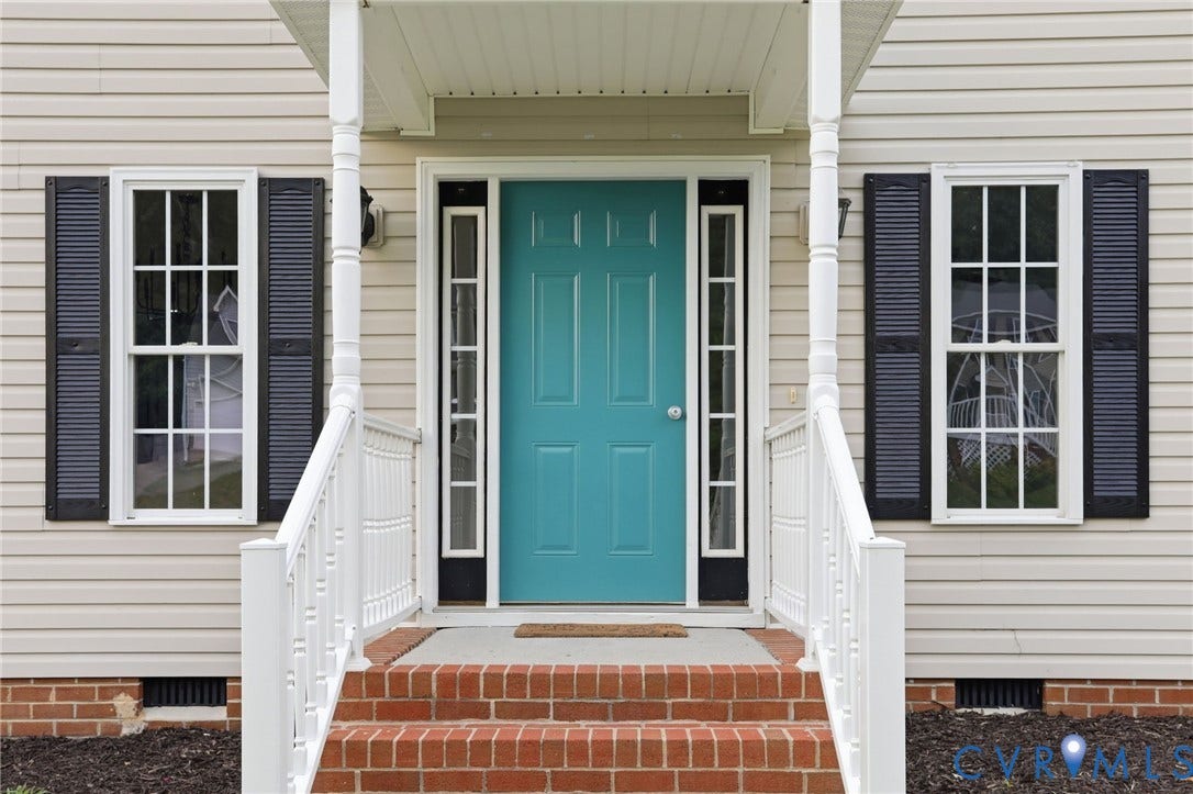 6412 Autumn Mist Way, Chesterfield, VA 23832 Welcoming front entry featuring a vibrant teal door, white vinyl siding, dark louvered shutters, brick steps, and white railings