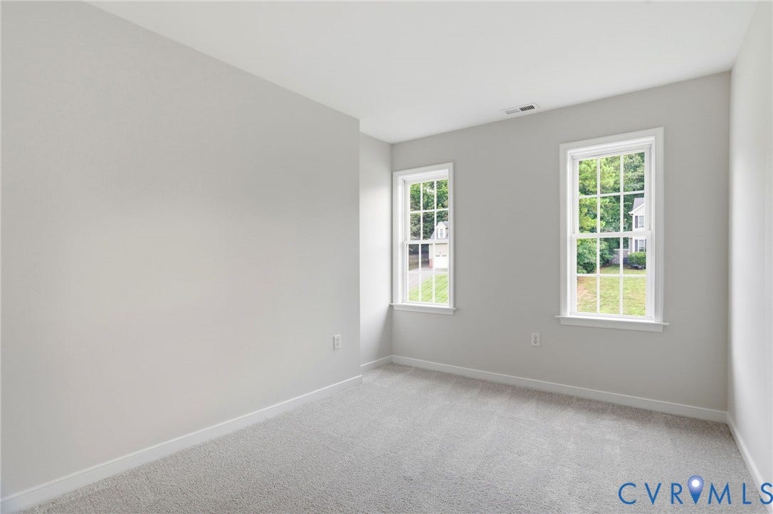 6412 Autumn Mist Way, Chesterfield, VA 23832 Neutral-toned room featuring light gray walls, two double-hung windows with white frames, and plush carpeting