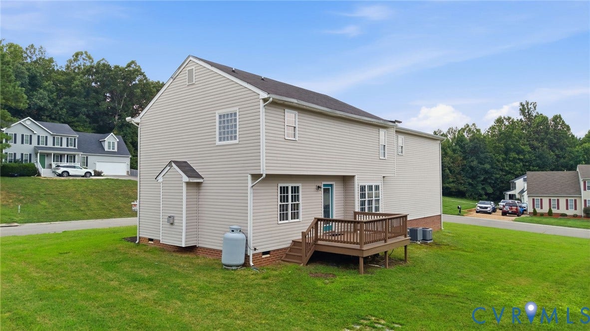 6412 Autumn Mist Way, Chesterfield, VA 23832 Rear exterior featuring a wooden deck, light-colored siding, multiple windows, and a manicured lawn